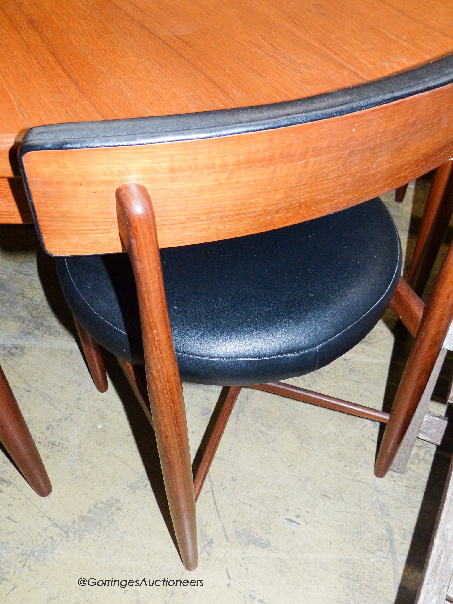 A teak and leatherette Fresco dining suite by Wilkins for G Plan, comprising circular extending dining table, 120cm diameter (166cm extended), height 73cm and four chairs